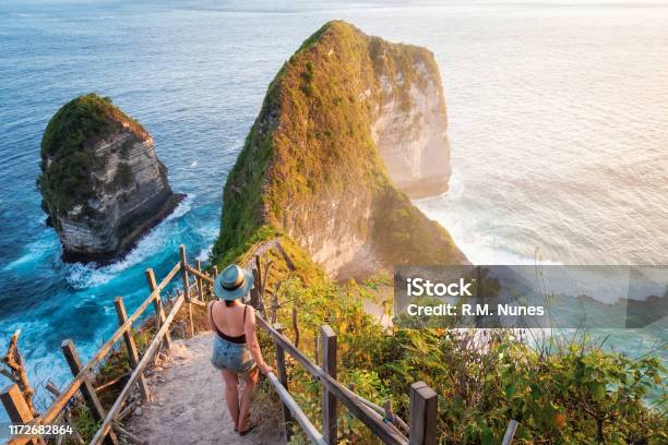 Bali Indonesia Traveler Watching The Sunset At Kelingking Beach In Nusa Penida Island Stock Photo - Download Image Now