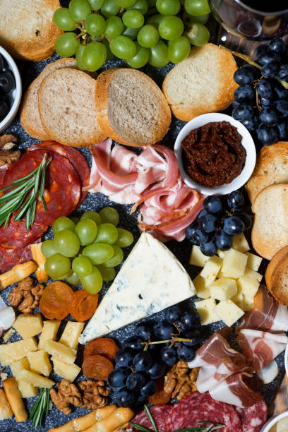 istock assorted cheeses, fruits and meats, top view vertical 1172682990