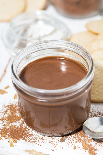 chocolate paste in a glass jar, vertical