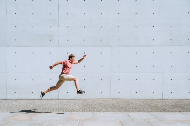 istock Young man jumping in urban environment 1172683112
