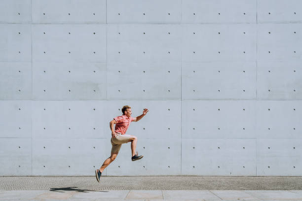 istock Young man jumping in urban environment 1172683167