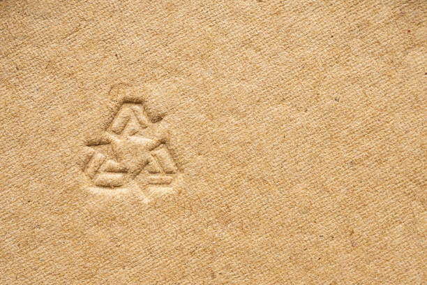 istock recycle sign on brown cardboard paper texture background 1172685753