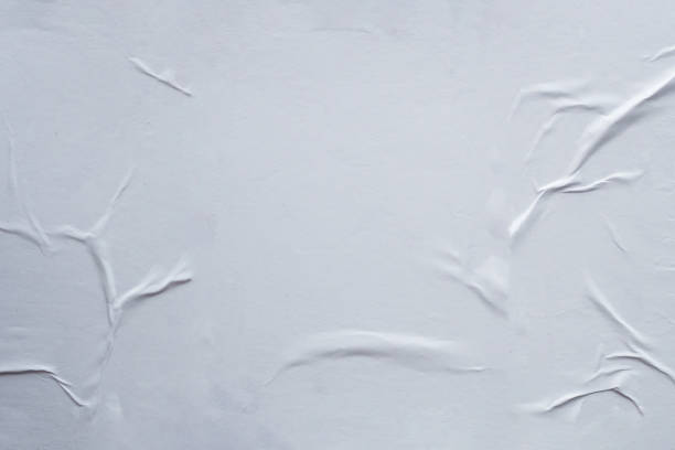 istock Blank white crumpled and creased paper poster texture background 1172685772