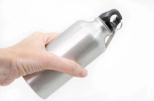 istock Female hand holding a reusable water bottle against a white background 1172687080