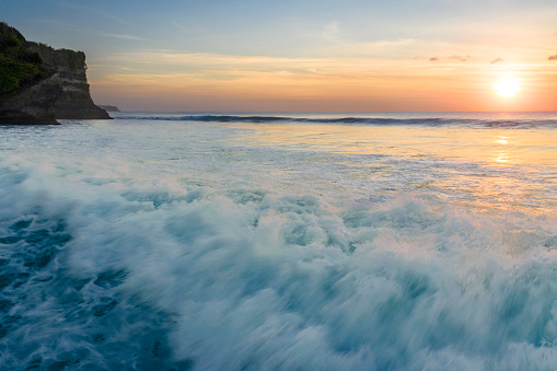 Large tropical waves crashing at sunset in Bali
