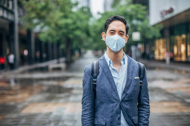 istock Gentleman with pollution mask on the street 1172687558