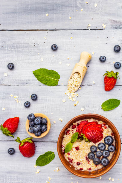istock Healthy breakfast vegetarian (vegan) concept. Oatmeal with fresh berries and mint 1172688512