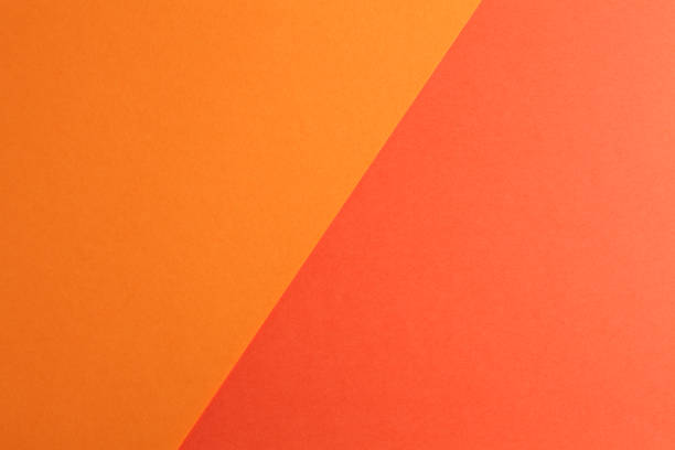 zweifarbiges papier - orange farbe stock-fotos und bilder