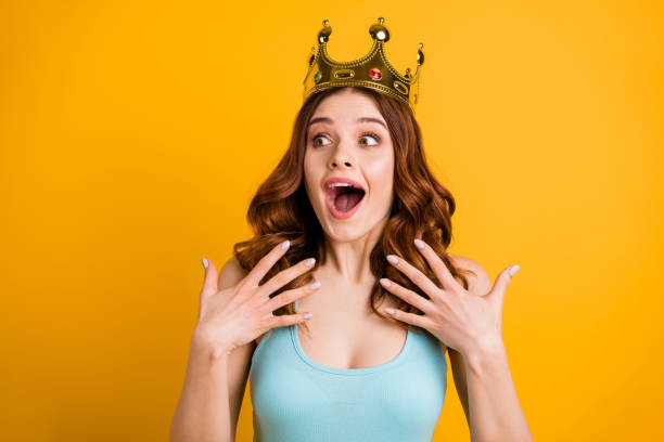 Photo of lady nominated as college celebrity wear big golden headwear and tank-top isolated yellow background Photo of lady nominated as college, celebrity wear big golden headwear and tank-top isolated yellow background princess crown tiara prom stock pictures, royalty-free photos & images