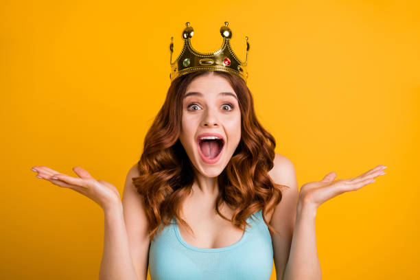 Photo of attractive celebrity lady yelling of positive emotions wear golden headwear and tank-top isolated yellow background Photo of attractive celebrity lady yelling of positive, emotions wear golden headwear and tank-top isolated yellow background prom queen stock pictures, royalty-free photos & images
