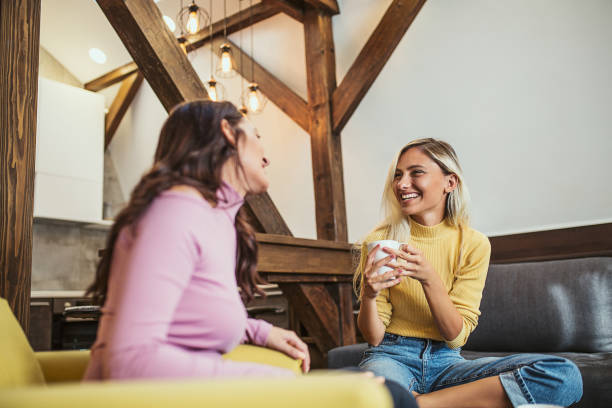 istock Two friends talk relaxed and have a fun time at home 1172690885