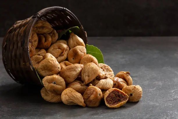 Dry fig pouring in basket