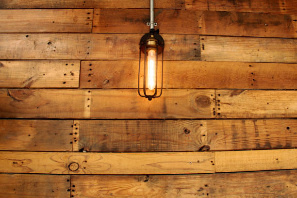 istock Textured wooden board with hanging light for exterior decoration 1172694137