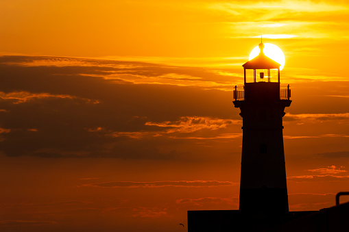 A breakwater lighthouse on Lake Superior at sunrise.