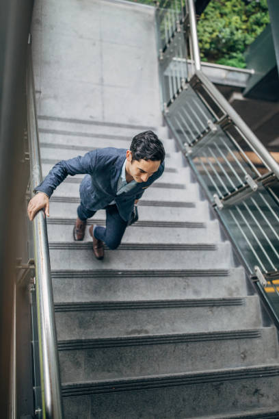 istock Handsome gentleman walking up the steps downtown in Taipei 1172699310