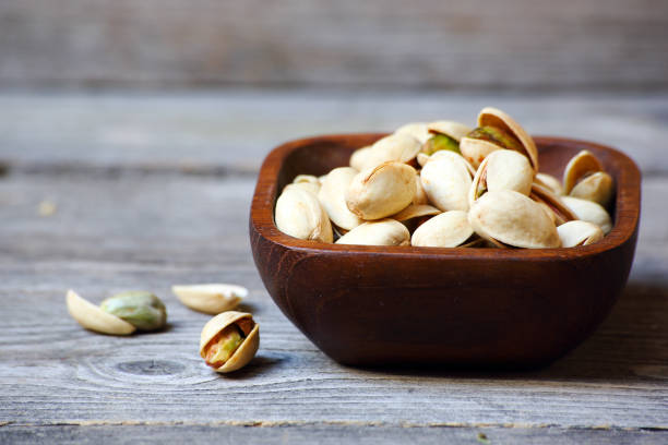 istock Pistachio nuts on a gray wooden table 1172699663