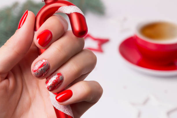 Christmas New Year manicure abstract nail design Christmas New Year manicure abstract nail design. Beautiful manicured woman's hand holding candy cane ornaments christmas nails stock pictures, royalty-free photos & images