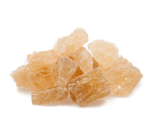 istock dark crystal sugar on white background 1172711147