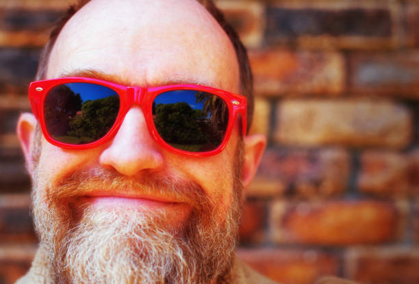 istock Bearded middle-aged man in red sunglasses 1172711874