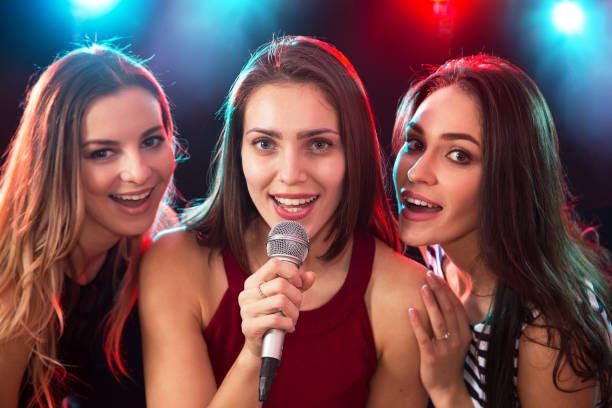 istock Girls having fun singing at a party 1172714286