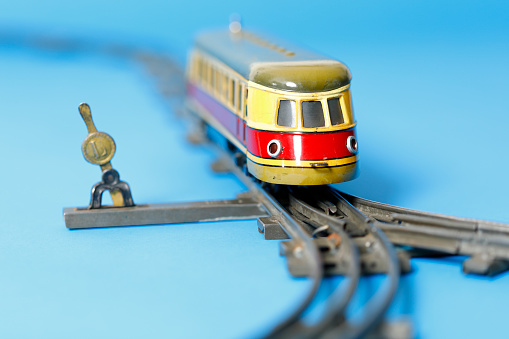 Electric tin toy locomotive at a railway switch