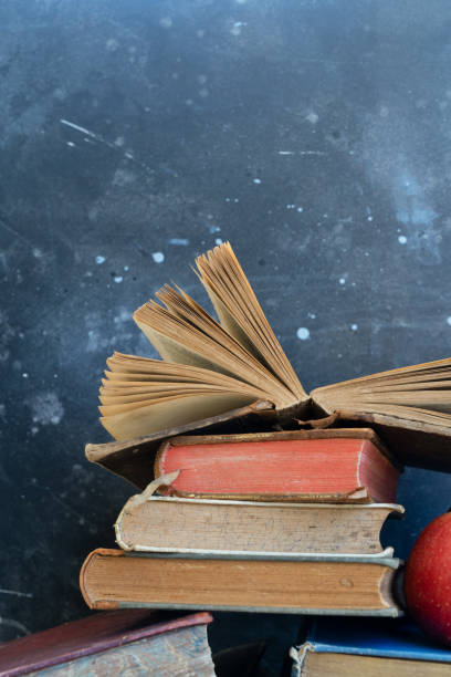 куча старых книг - book brown apple education стоковые фото и изображения