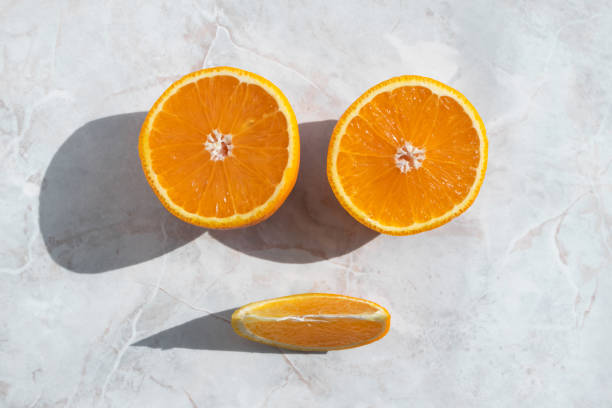 istock Top view on halved orange and slice on light background 1172719426