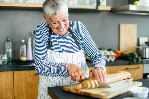 istock Cheerful senior woman in the kitchen 1172720621