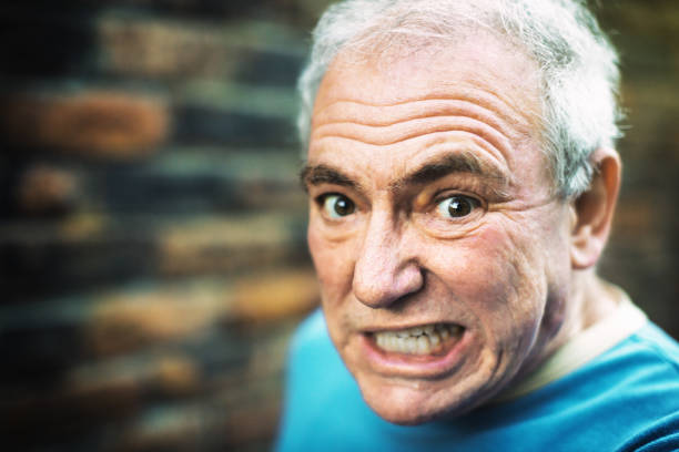 Senior man with a dramatic expression.