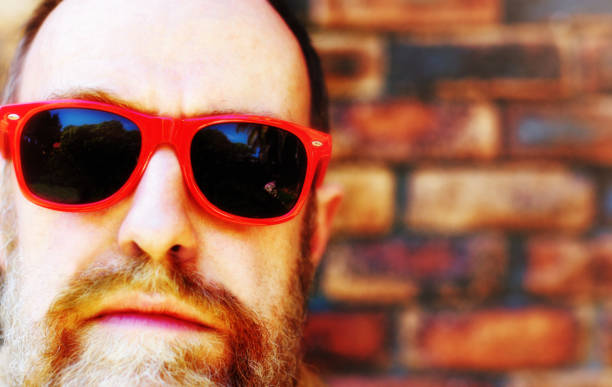 istock Bearded middle-aged man in red sunglasses 1172723434