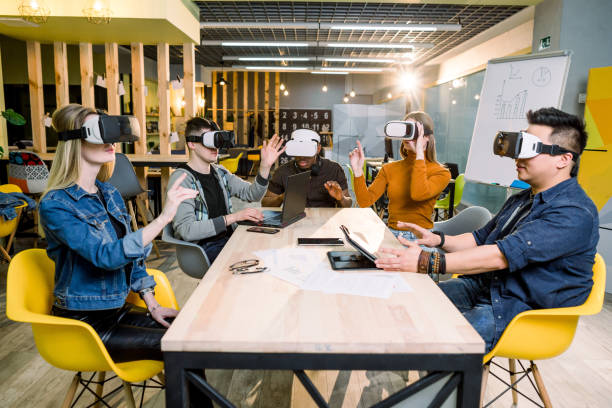 istock Teamwork trying virtual reality glasses for work in creative office. Young people using new technology at startup. Trends , social and business concept 1172723626