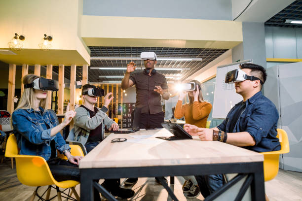 istock Future is right now. Confident creative young people adjusting virtual reality headset and smiling while sitting at working place in office 1172723720