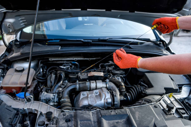 istock Human hands with oil level meter against car engine 1172723951