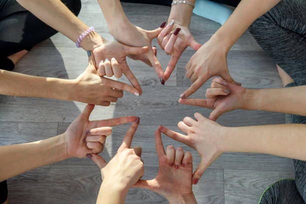 istock Circle of human hands doing yoga exercises close up 1172723998