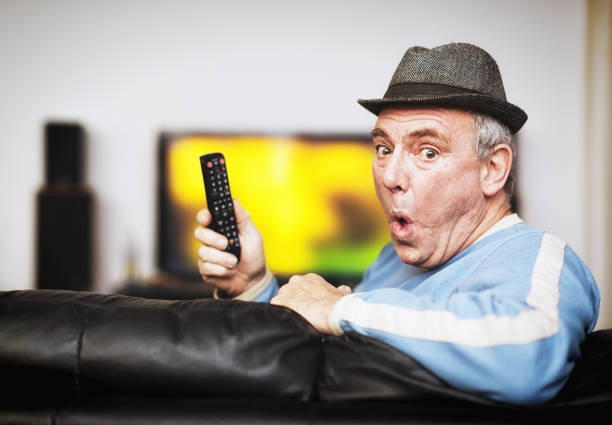 istock Senior man having problems with remote control as he watches TV 1172725010