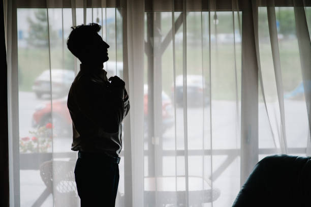 istock Silhouette man looking out the window. Side view. 1172726187