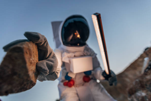 istock Astronaut picking up a rock from Mars 1172727808