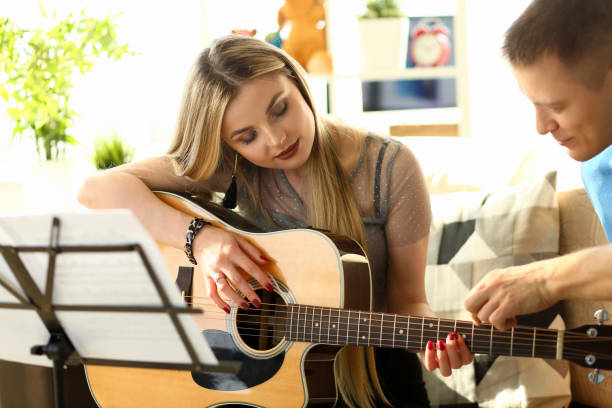 istock Musical Workshop at Home Couple Playing Guitar 1172727908