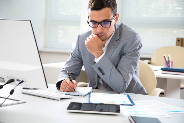 istock Young handsome businessman working in an office 1172729094