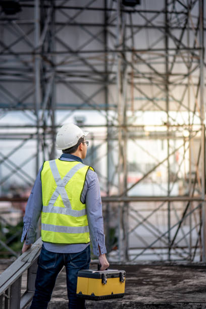 istock Worker man carrying aluminium ladder and tool box 1172730690