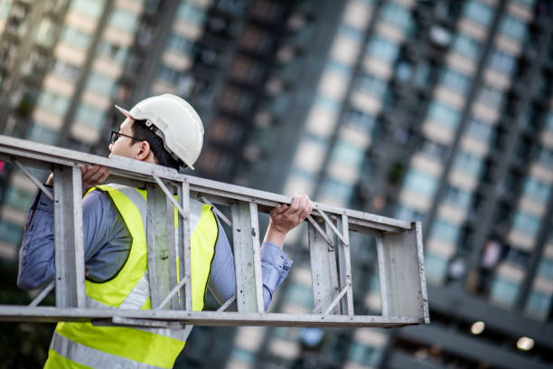 istock Maintenance worker man carrying aluminium ladder 1172731857