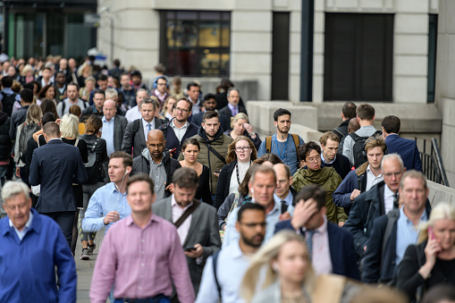 Large crowd of people commuting to work in London, England