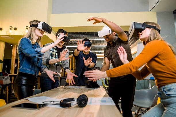 istock Young multiracial business People wearing virtual reality goggles with touching air during VR Meeting Conference at the office. Business men and women using VR goggles in meeting room. 1172732089