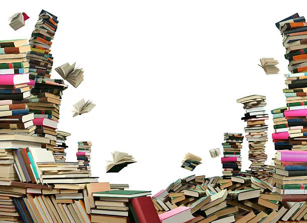 Photo of Big stacks of books with some books falling