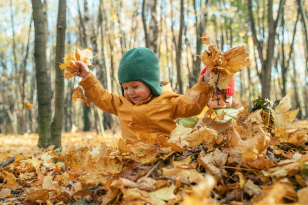 istock Child playing with leaves outdoors in autumn 1172733682