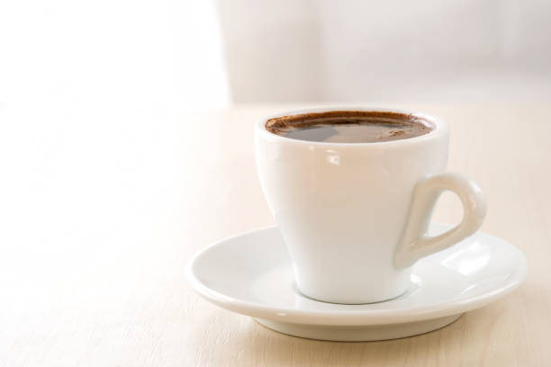istock A cup of coffee on a light beige background. Template for design, menu. 1172735224