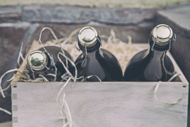 istock three champagne bottles in a wooden box on a stone wall background 1172736874