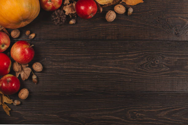 istock Autumn background with pumpkin, apples and nuts. Dark rustic wooden background. 1172738223