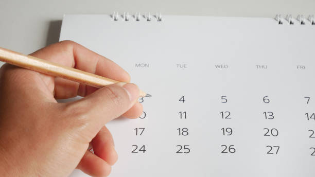 istock Hand writing and calendar on white tone. 1172739128