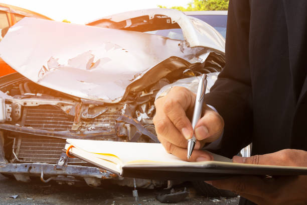 istock Insurance company representatives recording car accident damage. 1172739371